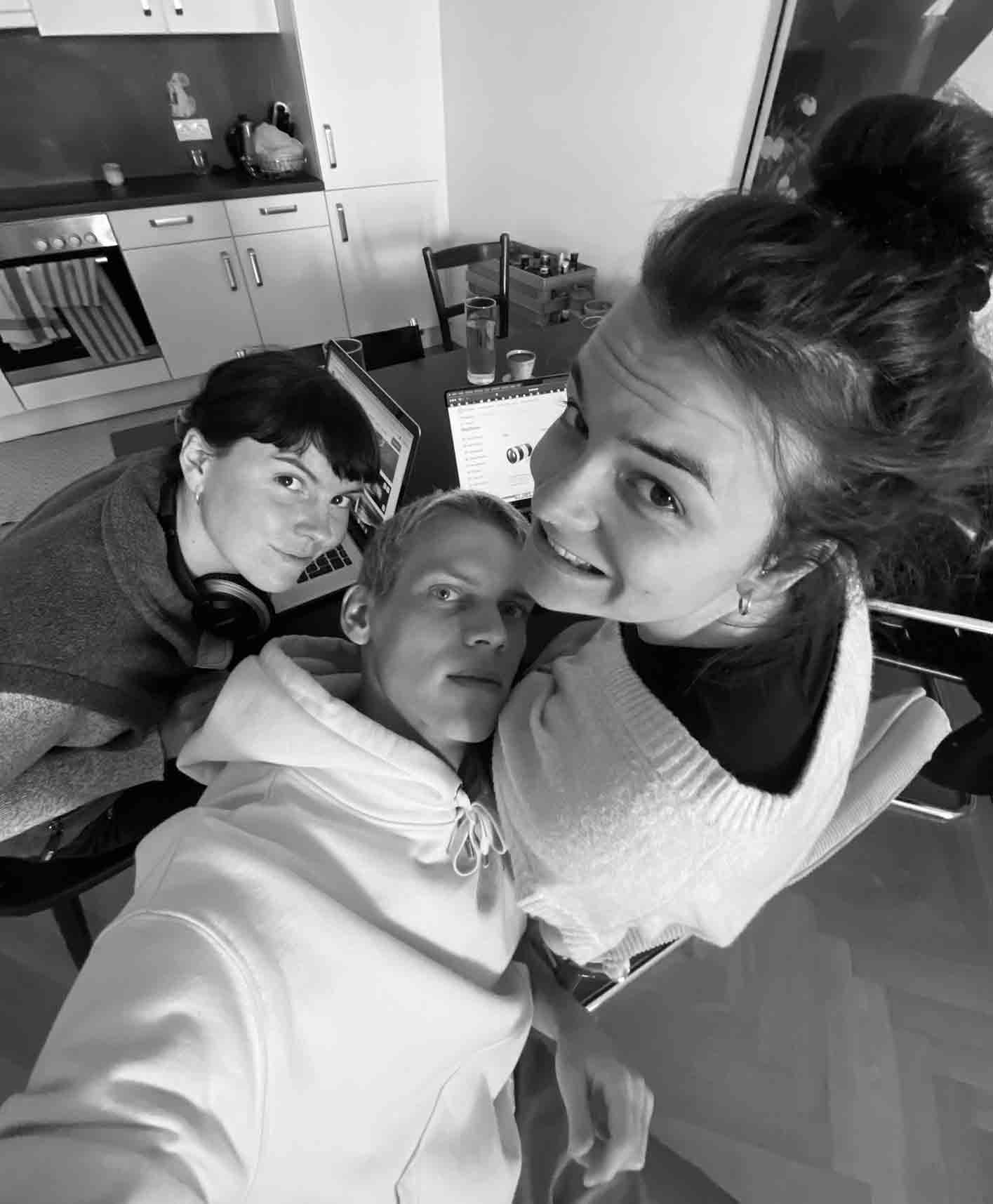 A black-and-white selfie of the three co-founders of RAWTY in fish-eye style working from home on their laptops.