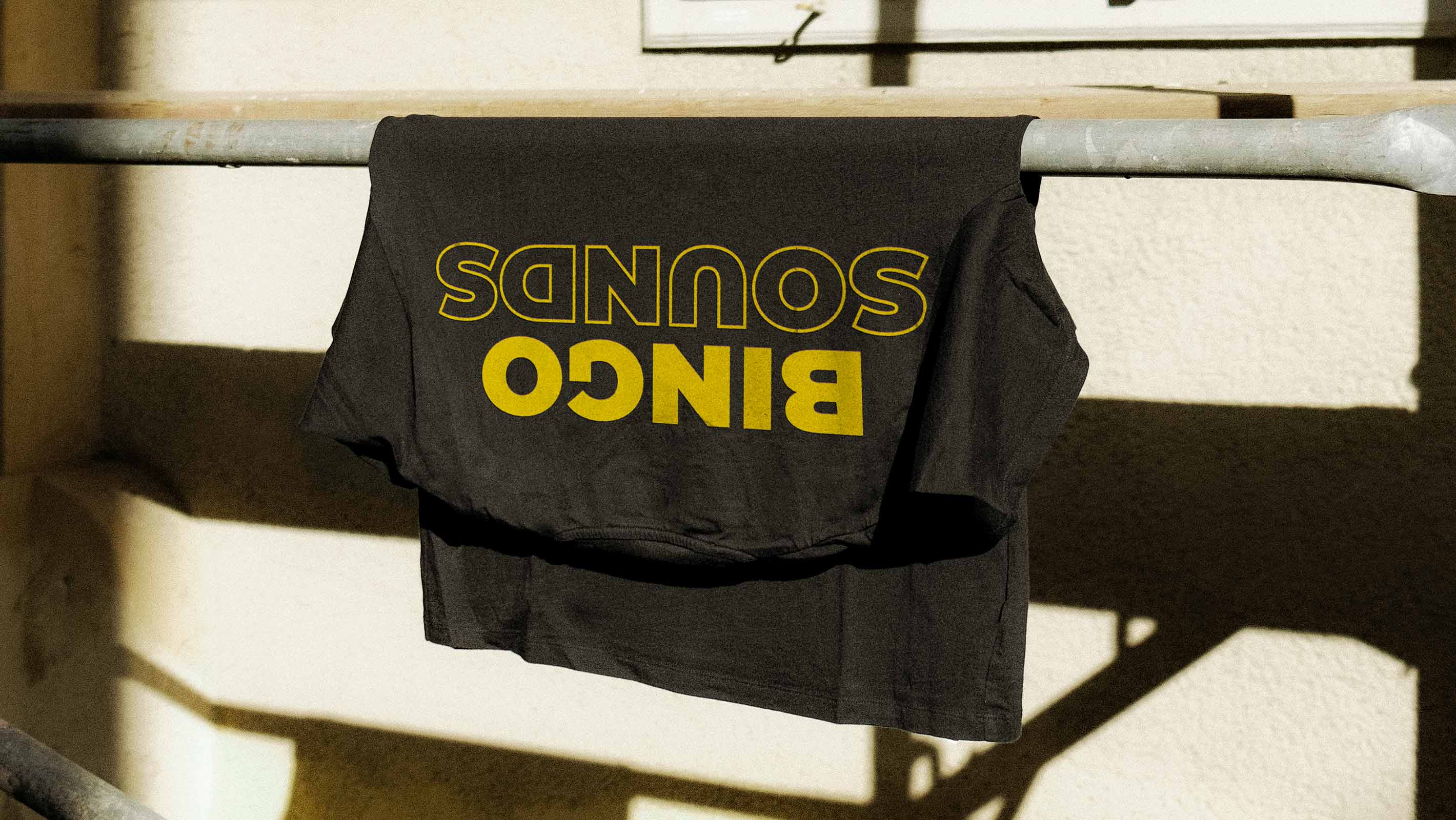 A photo of a black t-shirt with a large yellow 