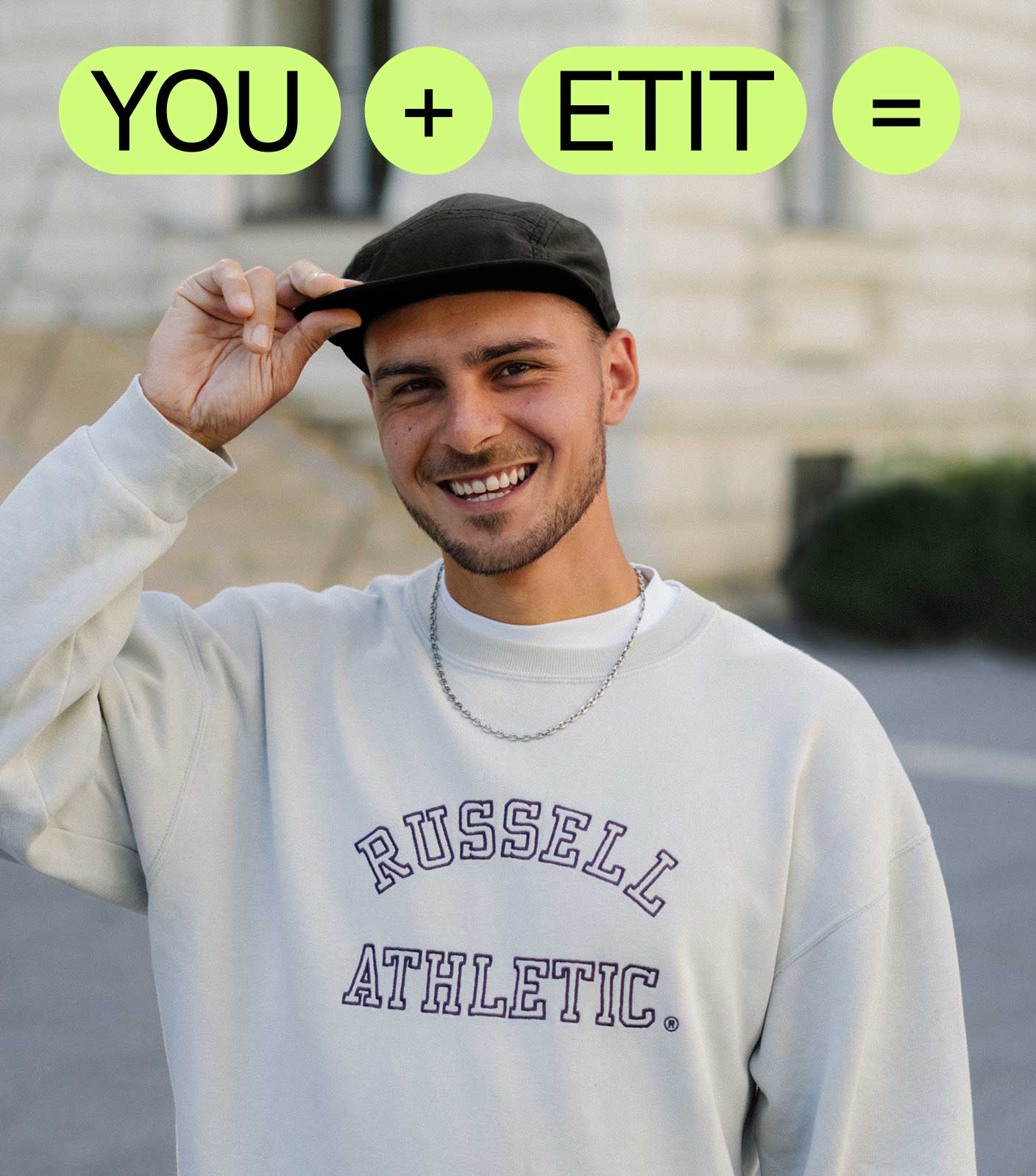 A photo of a young male student looking into the camera wearing a black cap and beige sweatshirt and the words 