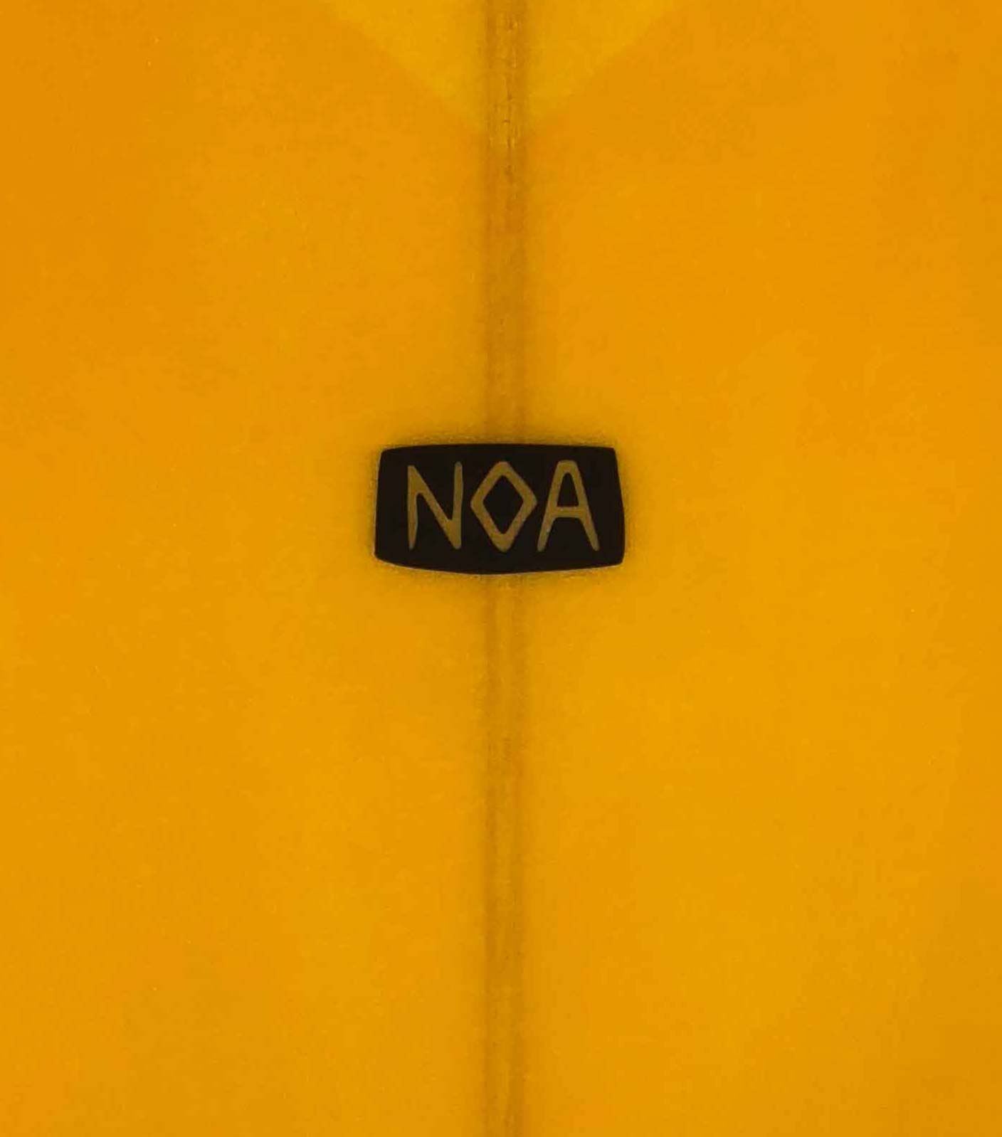 The NOA Surfboards logo on an orange surfboard.