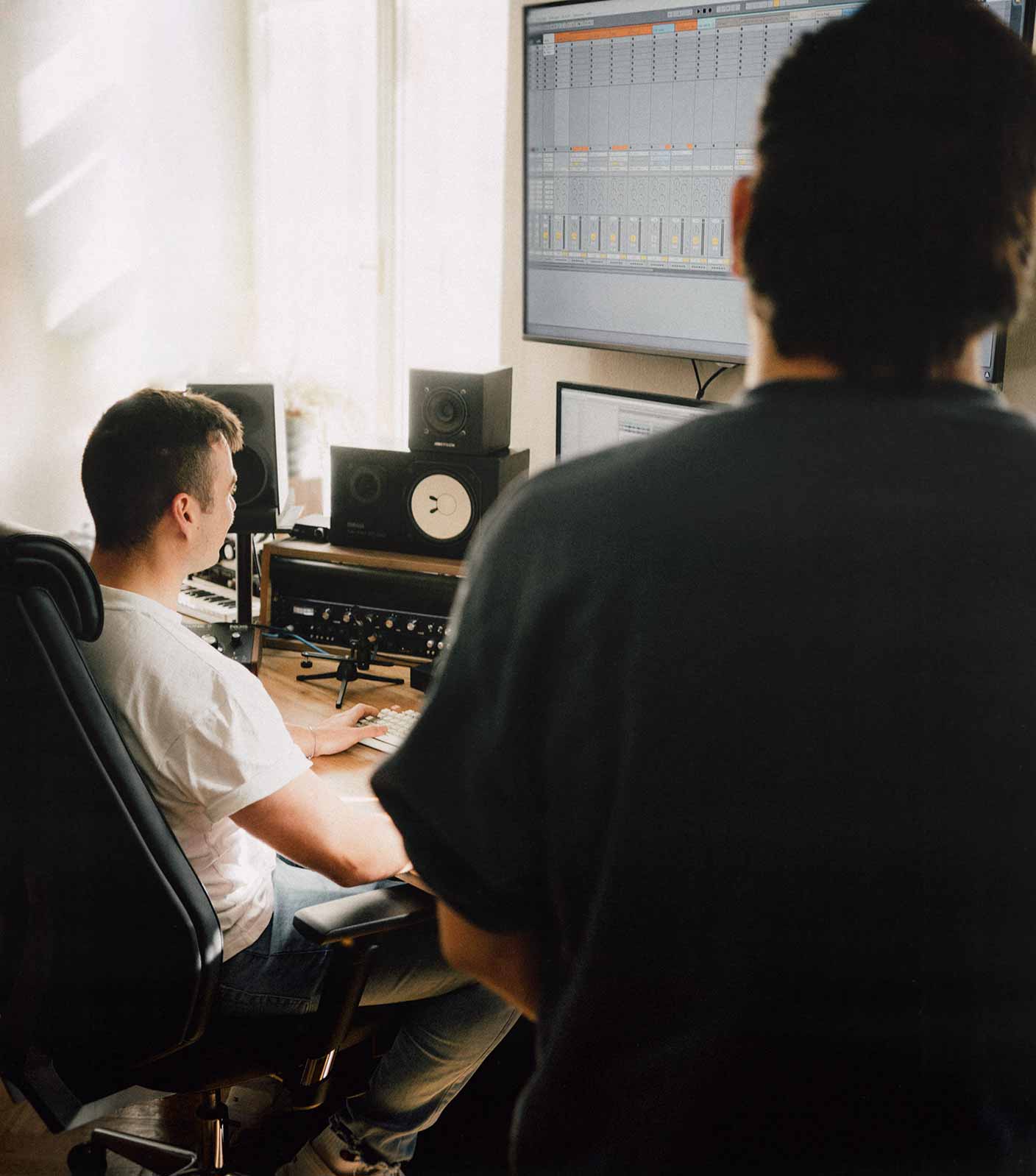 Two sound designers and music producers from unstudios in their studio working on a sound design project. Photo shot on Fujifilm X100V by Christian Leban.